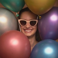 gift, girl and happy with sunglasses for balloons, celebration event and cool for birthday occasion. party, female teenager and portrait with accessory for fashion, excited and inflatable for decor - home decoration stock pic
