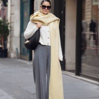 Gili Biegun wears grey pants, white knitted top with long sleeves, and pale yellow long wide scarf, balck leather bag and sunglasses during the...