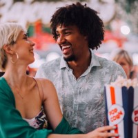 girl and boy eating popcorns - concert stock pictures, royalty-free photos & images