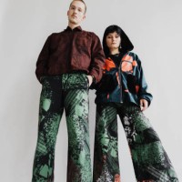 girl and boy stand close to each other wearing baggy clothing and looking into the camera - fashion stock pictures, royalty-free photos & images