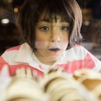 girl awed by chocolate bonbons in glass case - food stock pictures, royalty-free photos & images