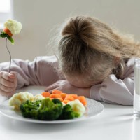 girl does not like to eat vegetables - junk food stock pictures, royalty-free photos & images