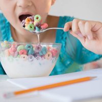 girl eating bowl of cereal - junk food stock pictures, royalty-free photos & images