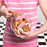 girl eating cookies - junk food stock pictures, royalty-free photos & images
