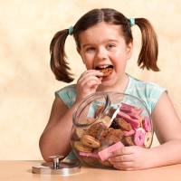 girl enjoying jar of cookies - junk food stock pictures, royalty-free photos & images