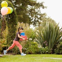 girl running at birthday party - garden decoration stock pictures, royalty-free photos & images