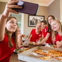 girl taking selfie with friends while eating pizza - junk food stock pictures, royalty-free photos & images