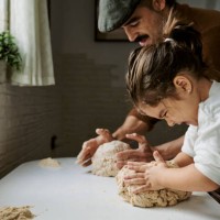 girl with her father making strength while kneading bread - food fotografías e imágenes de stock