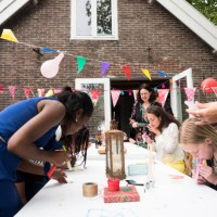 girls and women decorating for birthday party - garden decoration stock pictures, royalty-free photos & images