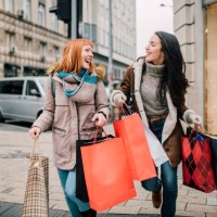 girls carrying shopping bags - fashion stock pictures, royalty-free photos & images