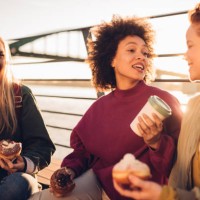 girls drinking coffee and eating donuts - junk food stock pictures, royalty-free photos & images