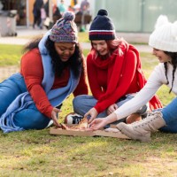 girls eating pizza in a park - junk food stock pictures, royalty-free photos & images