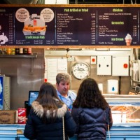 girls queuing at fish and chips counter, london, uk - junk food stock pictures, royalty-free photos & images