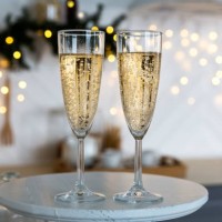glasses with champagne on the background of christmas decorations. - home decoration stock pictures, royalty-free photos & images