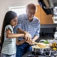 grandfather and granddaughter cooking in kitchen - food stock pictures, royalty-free photos & images