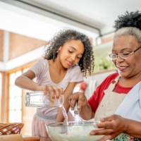 grandma and granddaughters making christmas cookies - food stock pictures, royalty-free photos & images
