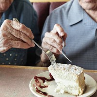 grandpa and grandma sharing cake - food stock pictures, royalty-free photos & images