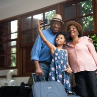 grandparents and granddaughter taking selfies after arriving in a hotel - travel stock pictures, royalty-free photos & images