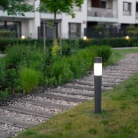 green building. lamps by the footpath in an elegant courtyard at evening. - garden decoration stock pictures, royalty-free photos & images