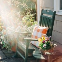 green rocking chair on a sunlit patio - garden decoration stock pictures, royalty-free photos & images