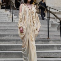Greta Ferro wears cream ruffled long dress, black boots, outside Zimmermann during the Womenswear Fall/Winter 2025/2026 as part of Paris Fashion Week...
