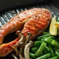 grilled salmon steak, baked piece of trout with green beans, shimeji mushrooms and lemon in a grilled pan. - junk food stock pictures, royalty-free photos & images