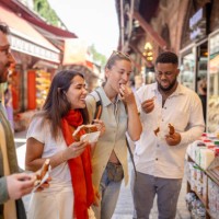 group enjoying street food in a bustling market - food stock pictures, royalty-free photos & images