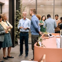 group of business people having casual conversation while on a refreshment break - food stockfoto's en -beelden