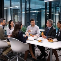 group of business people in a meeting eating breakfast - food stock pictures, royalty-free photos & images