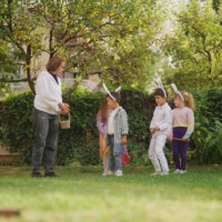 group of children playing egg and spoon race outdoors - garden decoration stock pictures, royalty-free photos & images