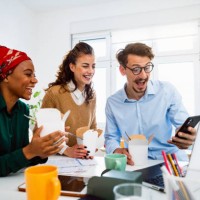 group of colleagues using mobile phone during office break time - junk food stock pictures, royalty-free photos & images