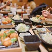 group of friend dinning traditional japanese food tonkatsu set with variety of japanese food - food stock pictures, royalty-free photos & images