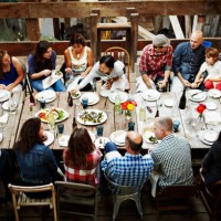 group of friends and family dining overhead view - food stock pictures, royalty-free photos & images