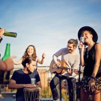 group of friends are celebrating with a concert on the roof terrace - concert stock pictures, royalty-free photos & images