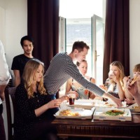 group of friends chatting over drinks and pizza at home - junk food stock pictures, royalty-free photos & images