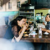 group of friends eating burgers together - junk food stock pictures, royalty-free photos & images