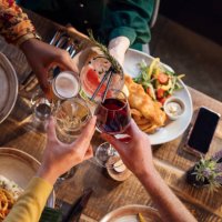 group of friends having a celebratory toast - food stock pictures, royalty-free photos & images