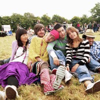 group of friends sitting on grass by crowd, portrait - concert stock pictures, royalty-free photos & images
