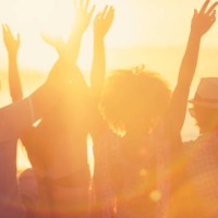group of friends sitting on the beach at sunset/sunrise. - concert stock pictures, royalty-free photos & images