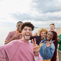 group of friends taking selfie on sunny beach - travel stock pictures, royalty-free photos & images