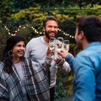 group of friends toasting with champagne during new years party - garden decoration stock pictures, royalty-free photos & images