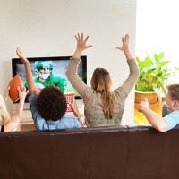 group of friends watching and cheering football game together - home decoration stock pictures, royalty-free photos & images