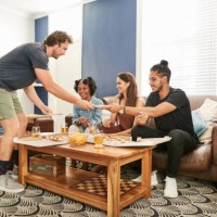group of multiracial young friends partying at home - junk food stock pictures, royalty-free photos & images