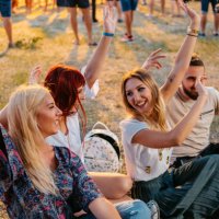 group of people sitting on a grass and dancing at the music festival - concert stock pictures, royalty-free photos & images