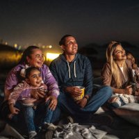 group of people watching a movie outdoors - concert stock pictures, royalty-free photos & images