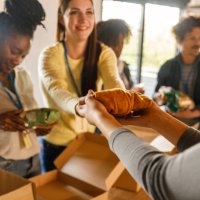 group of volunteers preparing donation boxes with clothes - food stock pictures, royalty-free photos & images