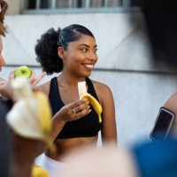 group of women eating banana after workout session - food stock pictures, royalty-free photos & images