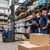 group of workers at a supermarket moving merchandise using a forklift - food stock pictures, royalty-free photos & images