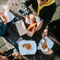 group of young adults eating fast food - junk food stock pictures, royalty-free photos & images
