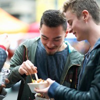 group of young adults eating takeaway food, outdoors - junk food stock pictures, royalty-free photos & images
